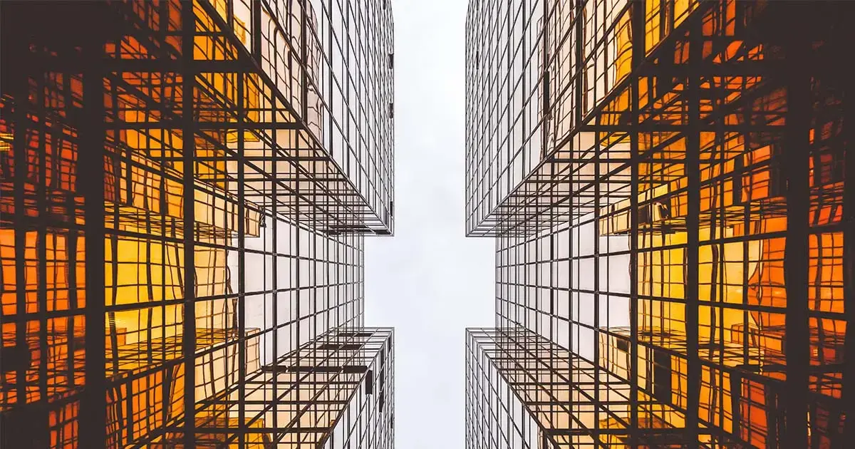 Symmetrical view of high-rise office buildings representing structured enterprise systems and centralised vendor data management.