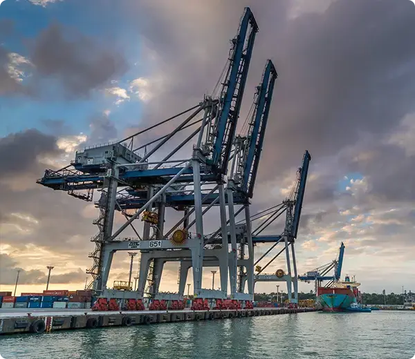 Container cranes at Ports of Auckland with cargo ship docked