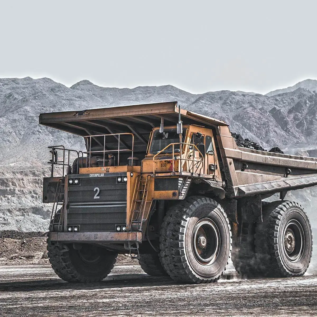 Heavy-duty Caterpillar mining truck in open-pit mine