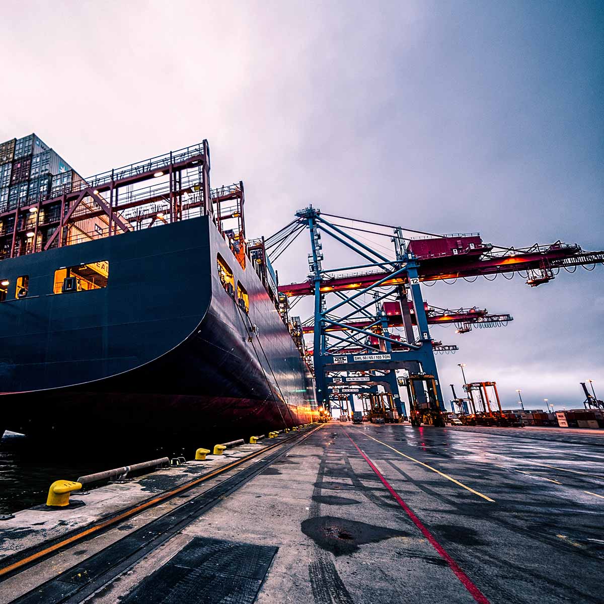 Cargo ship docked at a port symbolising Felix procurement for logistics and supply chain sectors.