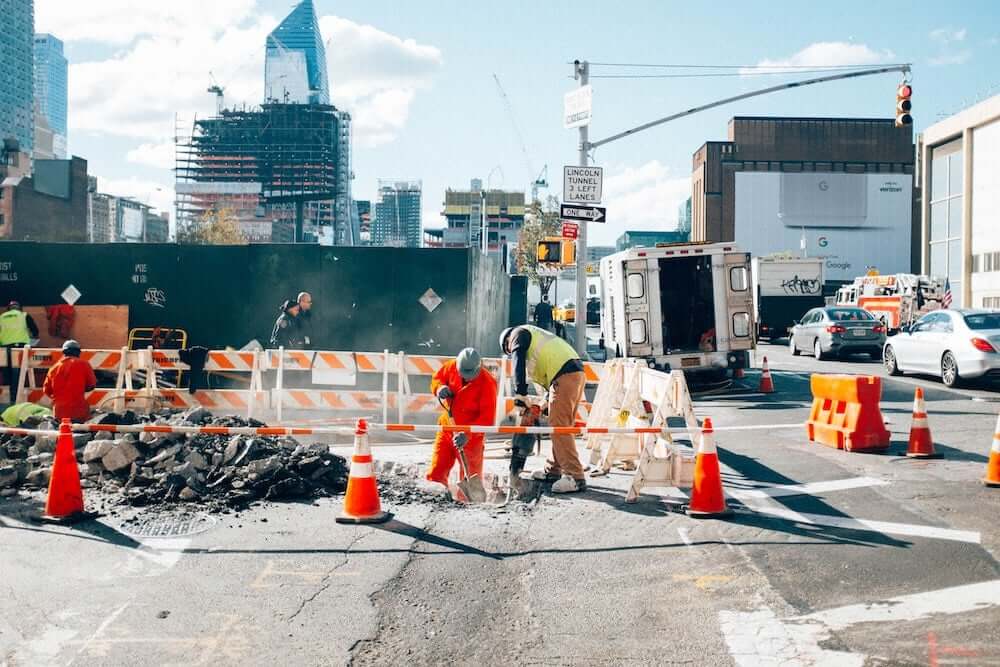 Construction crew working on a city street, representing the importance of vendor prequalification and safety compliance.